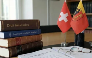 Swiss tax law publications and official documents on a desk